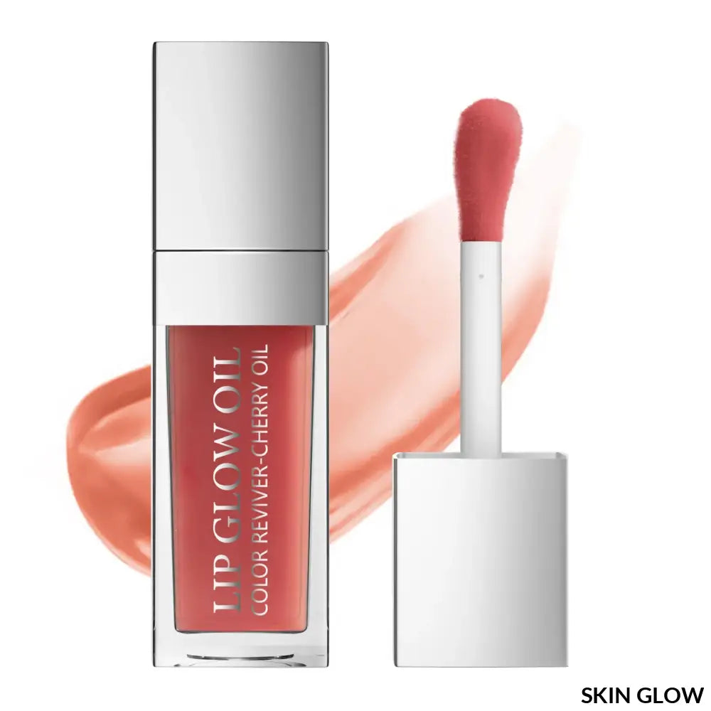 Coral lip oil gloss in a clear container with silver cap for perfect lips