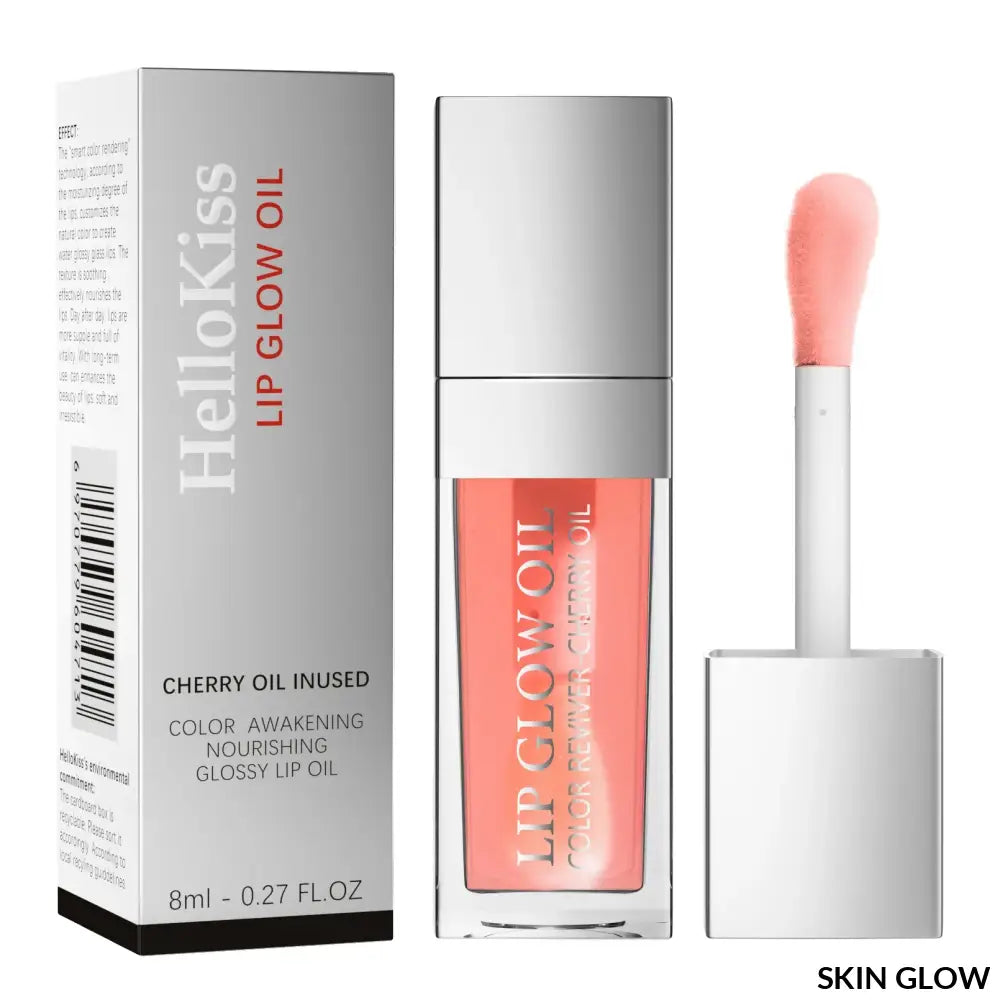 Coral lip oil gloss in a clear bottle with silver cap and applicator wand