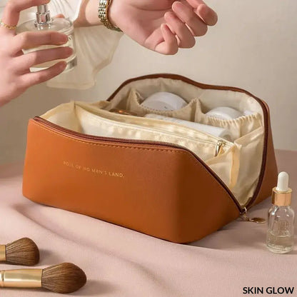 Tan leather cosmetic bag with cream interior, perfect for a makeup organizer kit